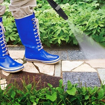 cleanind patio with pressure washer